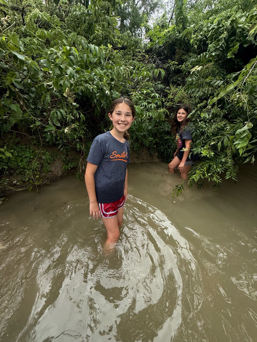 The twins wading in a pond hunting for lost golf balls